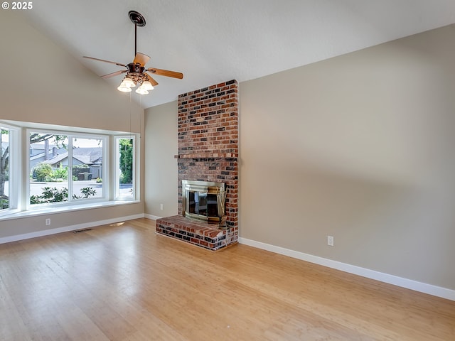 5367 NW 180th Pl, Portland, OR 97229 - unfurnished living room with a ceiling fan, light wood-style floors, a brick fireplace, and high vaulted ceiling