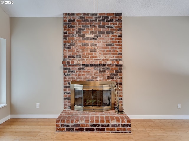 5367 NW 180th Pl, Portland, OR 97229 - detailed view of wood finished floors and a brick fireplace