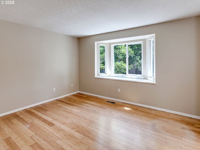 5367 NW 180th Pl, Portland, OR 97229 - unfurnished room featuring a textured ceiling and light wood-style flooring