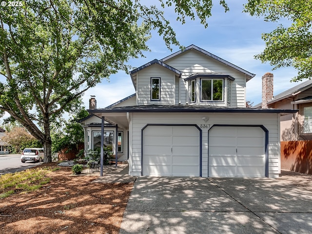 5367 NW 180th Pl, Portland, OR 97229 - view of front facade with an attached garage, driveway, and a chimney