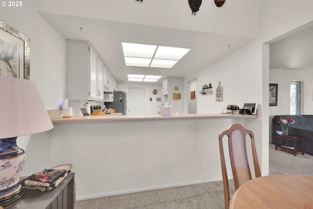 2062 Lake Isle Dr, Eugene, OR 97401 - kitchen with carpet flooring, freestanding refrigerator, and baseboards
