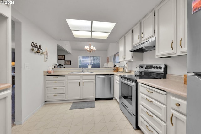 2062 Lake Isle Dr, Eugene, OR 97401 - kitchen featuring appliances with stainless steel finishes, under cabinet range hood, a chandelier, light countertops, and white cabinetry