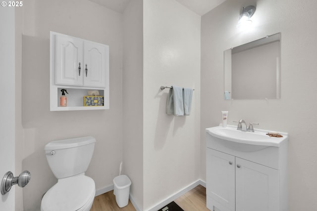 2062 Lake Isle Dr, Eugene, OR 97401 - half bathroom with wood finished floors, vanity, toilet, and baseboards