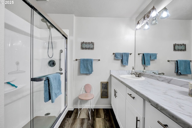 2062 Lake Isle Dr, Eugene, OR 97401 - bathroom with vanity, wood finished floors, and a shower stall
