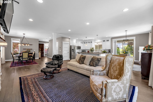 living room featuring wood finished floors, recessed lighting, and baseboards