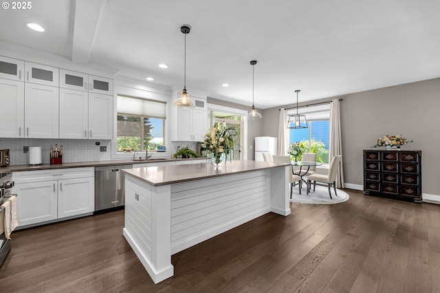 kitchen featuring stainless steel appliances, dark wood-style floors, white cabinetry, a center island, and recessed lighting