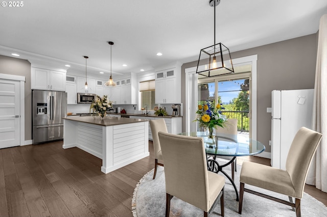 dining area with recessed lighting and dark wood-type flooring