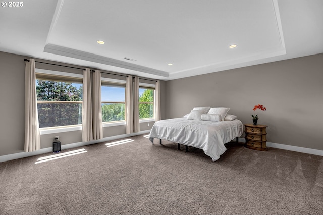 carpeted bedroom with a tray ceiling, multiple windows, recessed lighting, and baseboards