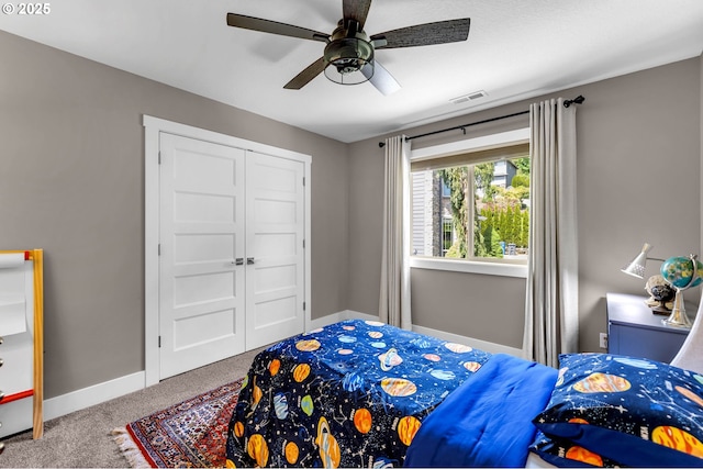 bedroom featuring carpet flooring, baseboards, a closet, and ceiling fan