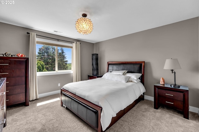bedroom featuring baseboards and light colored carpet
