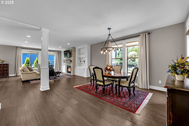 dining room with decorative columns, dark wood finished floors, baseboards, a fireplace, and recessed lighting