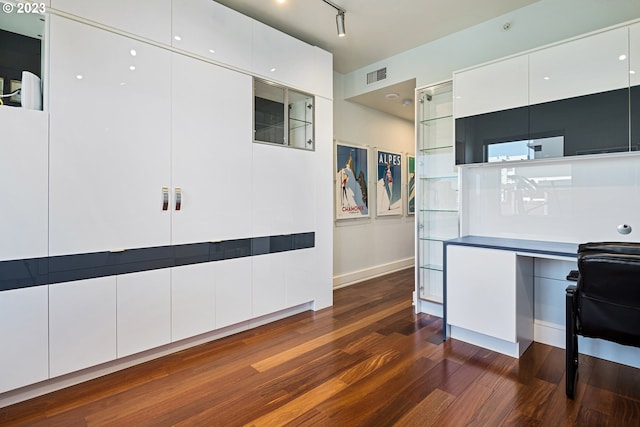 kitchen featuring white cabinets, dark wood finished floors, visible vents, modern cabinets, and baseboards