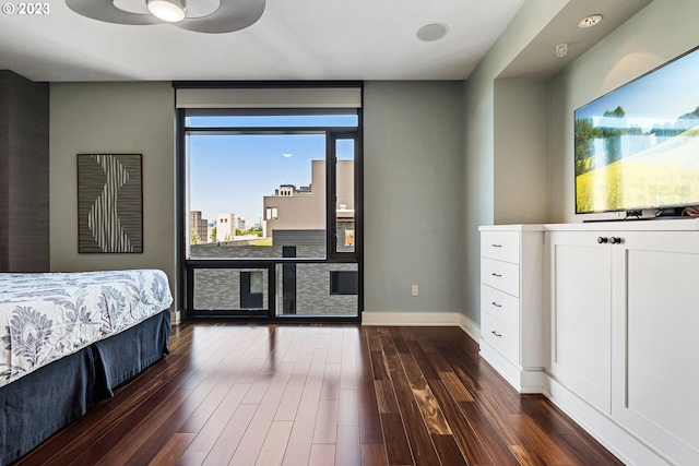 bedroom featuring baseboards and dark wood-type flooring