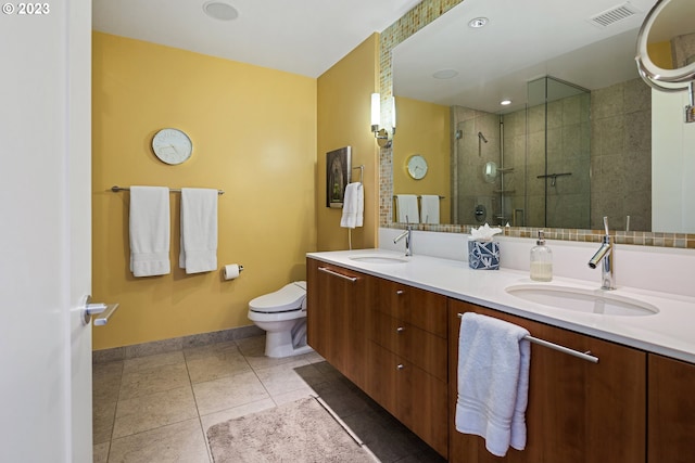 full bathroom featuring a sink, a stall shower, baseboards, and visible vents