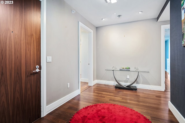 foyer entrance with recessed lighting, baseboards, and wood finished floors