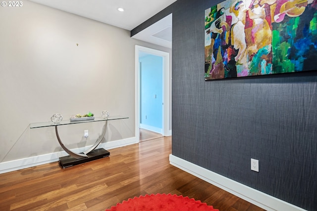 corridor with recessed lighting, baseboards, and wood finished floors