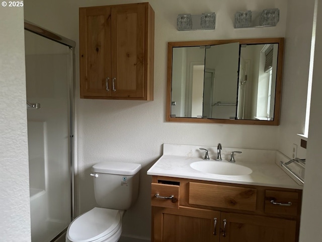 bathroom with vanity, an enclosed shower, and toilet