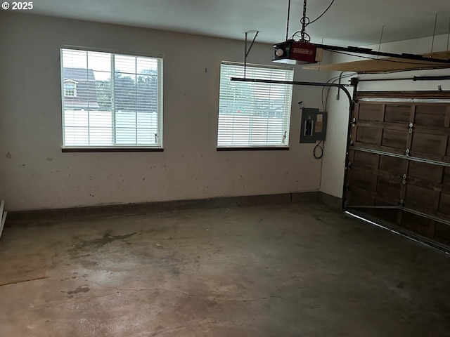 garage featuring electric panel and a garage door opener