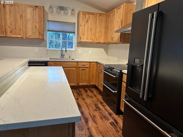 kitchen with dark wood-type flooring, black appliances, sink, vaulted ceiling, and extractor fan