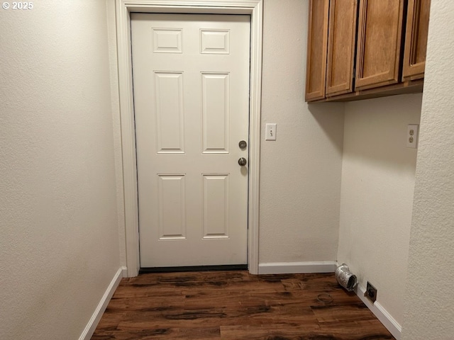 clothes washing area with cabinets and dark hardwood / wood-style flooring