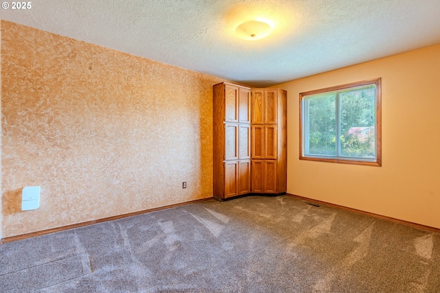 975 SW Florence Ct, Gresham, OR 97080 - spare room featuring a textured ceiling, carpet, and baseboards