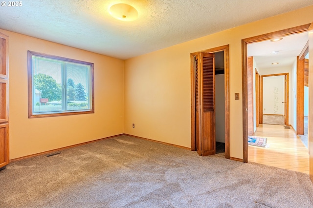 975 SW Florence Ct, Gresham, OR 97080 - unfurnished bedroom with a textured ceiling, light colored carpet, a closet, and baseboards