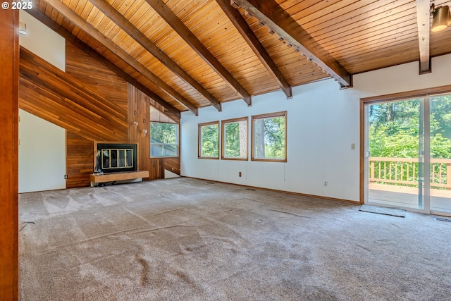 975 SW Florence Ct, Gresham, OR 97080 - unfurnished living room with wooden ceiling with exposed beams, carpet floors, plenty of natural light, high vaulted ceiling, and wood walls