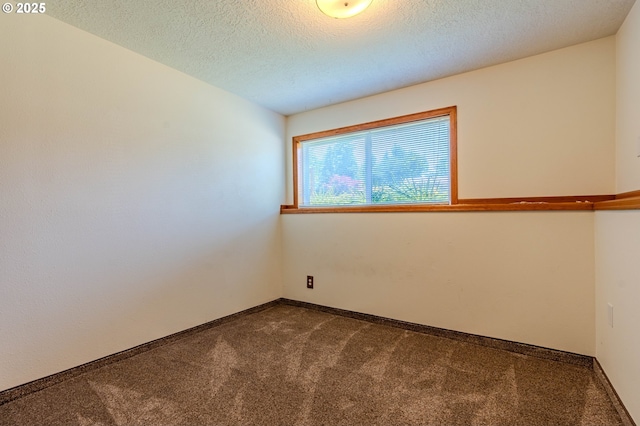 975 SW Florence Ct, Gresham, OR 97080 - unfurnished room with dark colored carpet, a textured ceiling, and baseboards