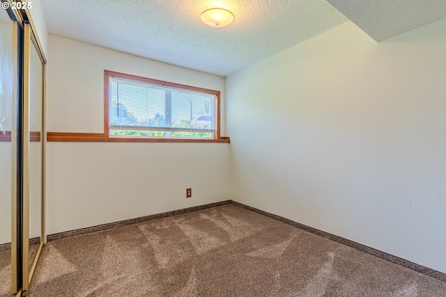 975 SW Florence Ct, Gresham, OR 97080 - unfurnished bedroom with carpet floors, a closet, baseboards, and a textured ceiling