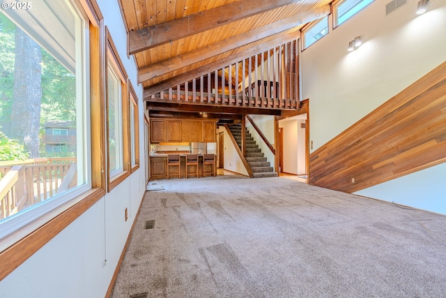 975 SW Florence Ct, Gresham, OR 97080 - unfurnished living room with wooden ceiling with exposed beams, carpet, and high vaulted ceiling