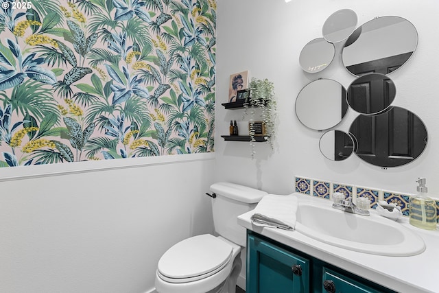 half bathroom with toilet and vanity