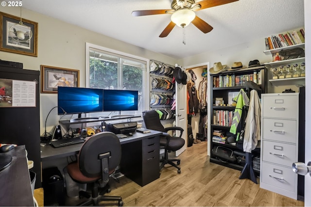 office area with a ceiling fan and wood finished floors