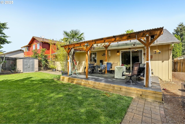 rear view of property with a storage shed, an outdoor structure, a deck, a fenced backyard, and a lawn