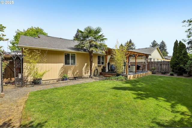 rear view of house featuring a yard, fence, and a patio area