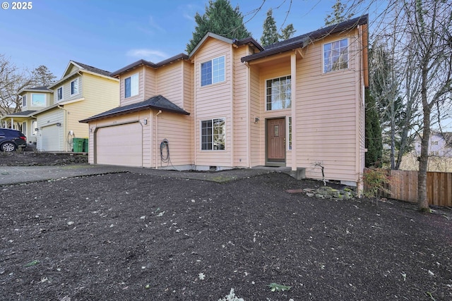 view of front facade with aphalt driveway, an attached garage, and fence