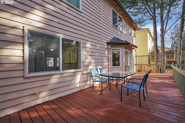 wooden terrace with outdoor dining space