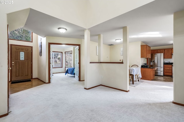 entryway with light carpet and baseboards