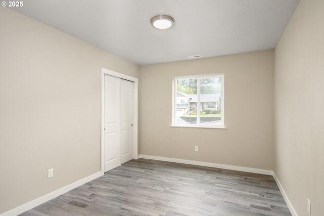 1516 Samuel Dr, Cottage Grove, OR 97424 - unfurnished bedroom featuring wood finished floors, baseboards, and a closet