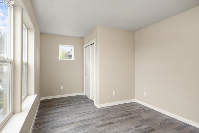 1516 Samuel Dr, Cottage Grove, OR 97424 - unfurnished bedroom featuring dark wood-style floors, baseboards, and a closet