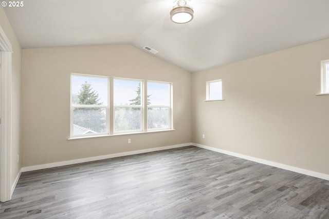 1516 Samuel Dr, Cottage Grove, OR 97424 - empty room featuring vaulted ceiling, wood finished floors, and baseboards