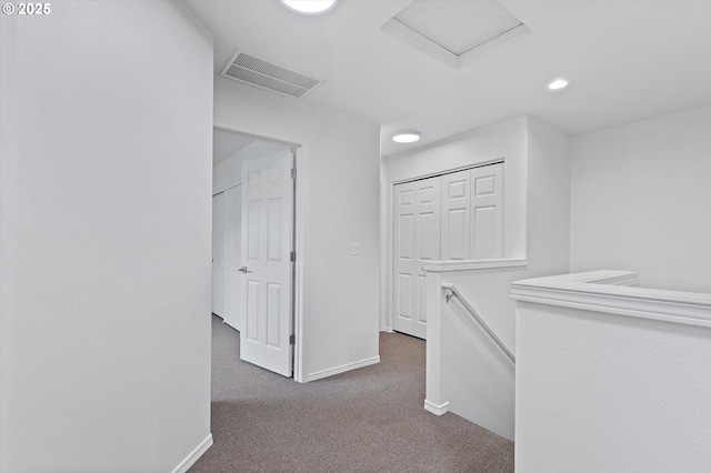 hallway with dark carpet