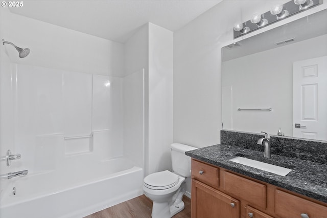 full bathroom featuring vanity, toilet, wood-type flooring, and bathtub / shower combination