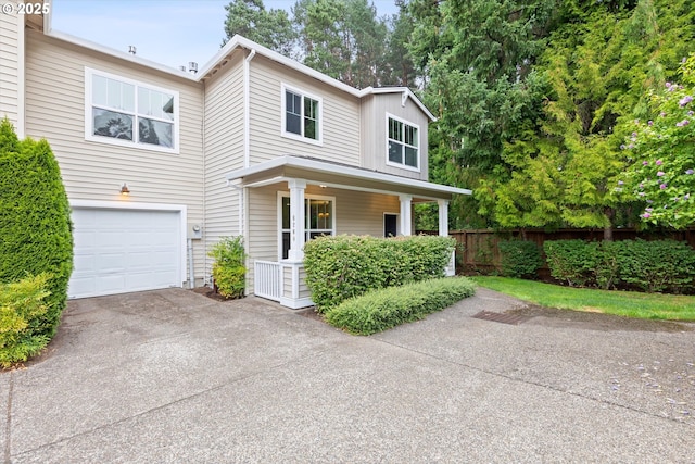 view of front of property featuring covered porch and a garage