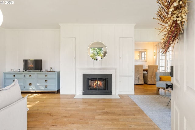 7985 SW Maple Dr, Portland, OR 97225 - living area featuring light wood finished floors, plenty of natural light, and ornamental molding