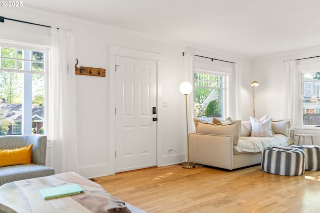 7985 SW Maple Dr, Portland, OR 97225 - sitting room with light wood-style flooring, healthy amount of natural light, ornamental molding, baseboards, and a fireplace with flush hearth