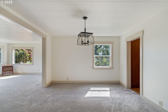 512 Evergreen Dr, Tillamook, OR 97141 - spare room with a wood stove, light carpet, and healthy amount of natural light