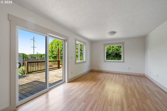 512 Evergreen Dr, Tillamook, OR 97141 - spare room with light wood-type flooring, baseboards, and a textured ceiling