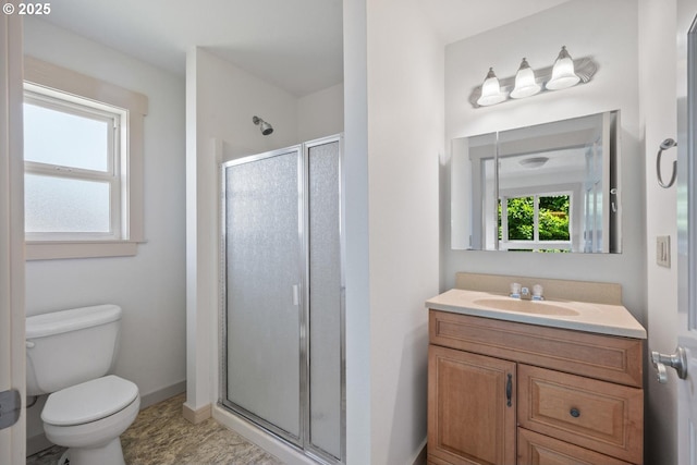 512 Evergreen Dr, Tillamook, OR 97141 - bathroom with a stall shower, toilet, vanity, and baseboards