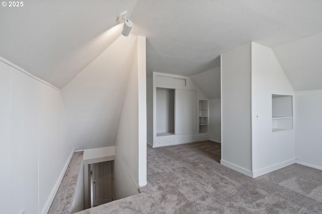 512 Evergreen Dr, Tillamook, OR 97141 - bonus room featuring carpet flooring, lofted ceiling, baseboards, and a textured ceiling