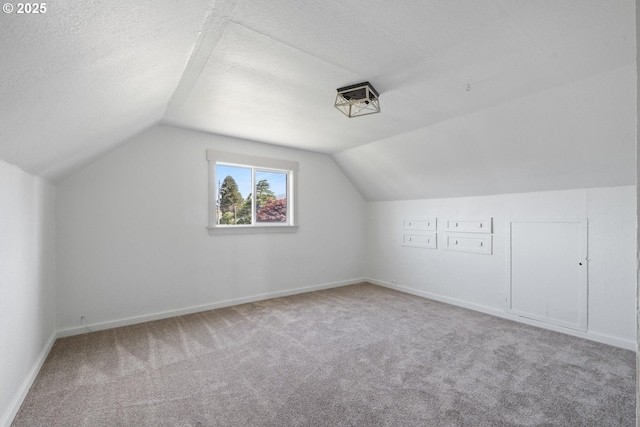 512 Evergreen Dr, Tillamook, OR 97141 - bonus room featuring carpet, lofted ceiling, baseboards, and a textured ceiling